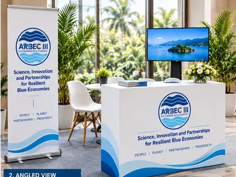 The booth design seen at an angle: the branded counter, the roll-up banner and white chairs around a small table