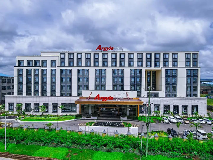 Front of the Argyle Grand Hotel Nairobi, a white multi-storey building with the hotel sign above the entrance canopy and a lawn in front